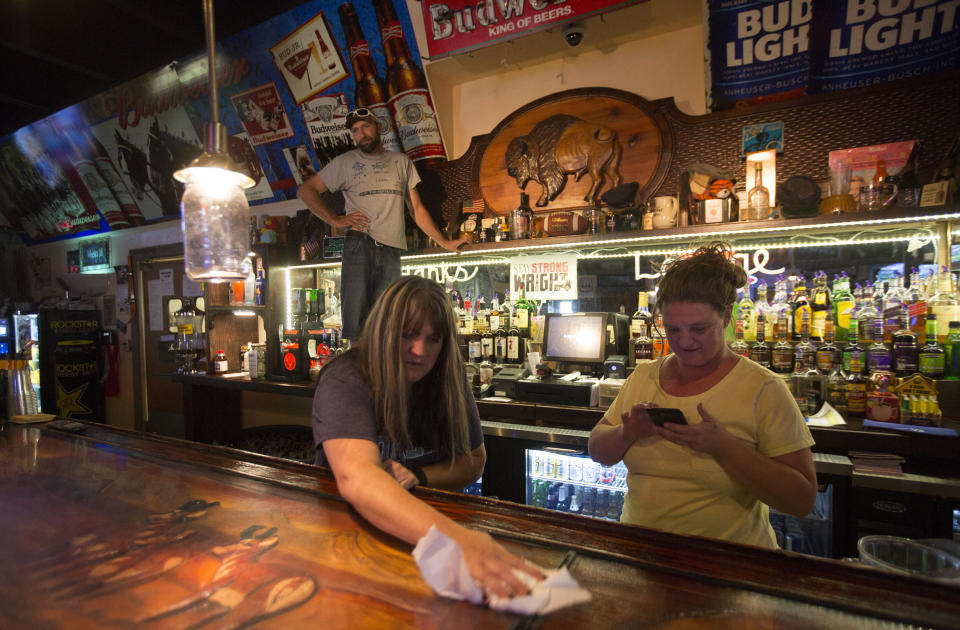 Lori Sanders, a bartender at Hank's Roadside Bar and Grill in Wright, wipes down the bar. “We don’t put anybody to the side because of who they are,” she said of Wyomingites.