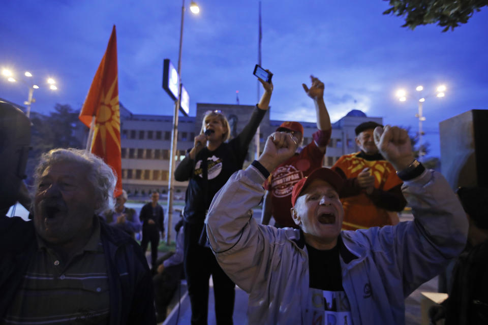 Protesters that had urged voters to boycott Sunday's referendum chant slogans as they demonstrate in Skopje, Macedonia, Sunday, Sept. 30, 2018. A crucial referendum on changing the nation of Macedonia's name to North Macedonia to pave the way for NATO membership attracted tepid voter participation Sunday. (AP Photo/Thanassis Stavrakis)