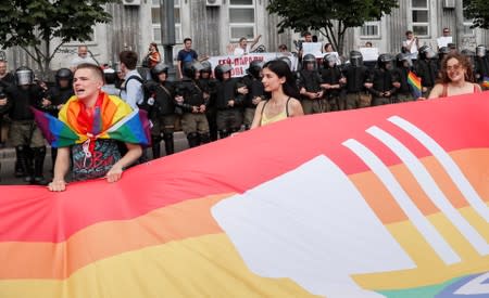 Participants hold a large rainbow flag at the Equality March, organized by the LGBT community in Kiev