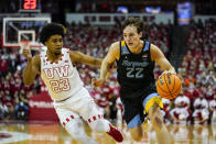 Marquette's Tyler Kolek (22) drives against Wisconsin's Chucky Hepburn (23) during the first half of an NCAA college basketball game Saturday, Dec. 4, 2021, in Madison, Wis. (AP Photo/Andy Manis)