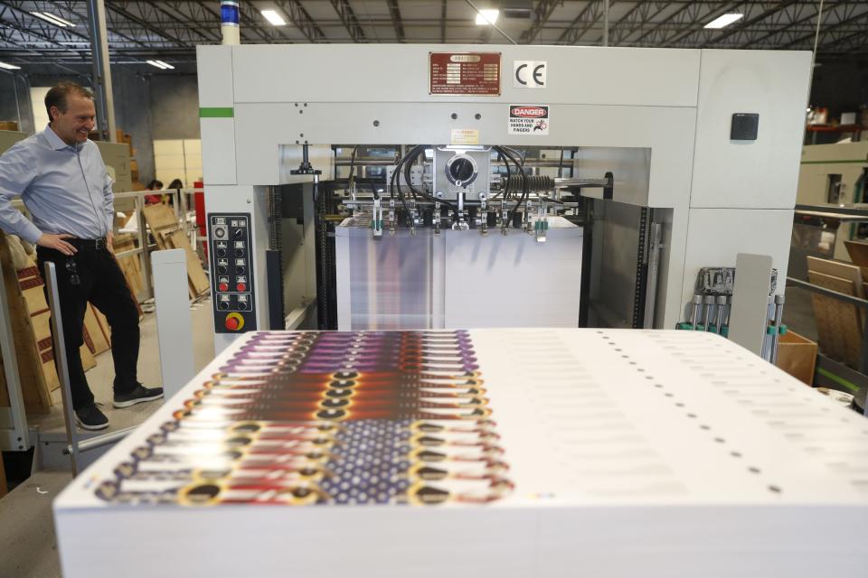 A machine prints the outline of the solar eclipse glasses at American Paper Optics in Bartlett on May 4, 2023. The company is making millions of pairs of solar eclipse glasses.