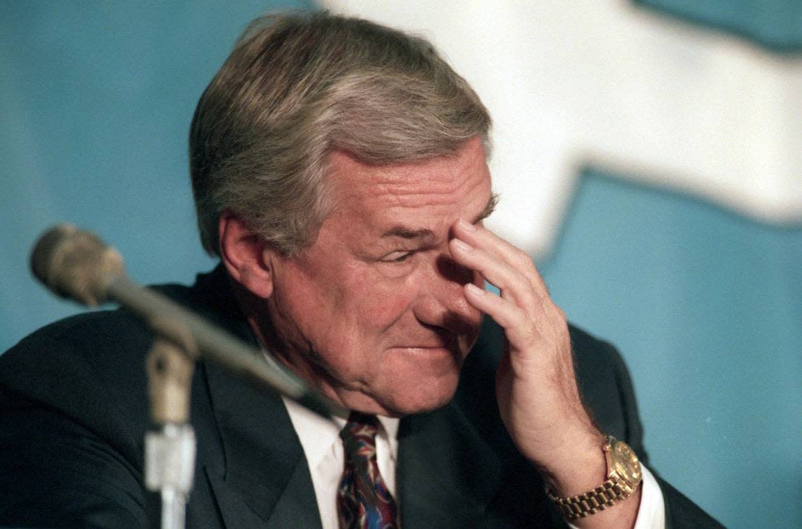 UNC’s Dean Smith wipes away a tear during an emotion moment in the press conference announcing his resignation as head basketball coach at UNC.