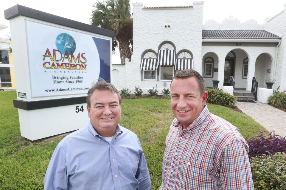 John Adams (at left), president of the Adams Cameron & Co. Realitors, poses with brother Ryan Adams, a top sales associate, in front of the company's office on Atlantic Avenue in Ormond Beach. Adams, Cameron is celebrating its 60th anniversary this year.
