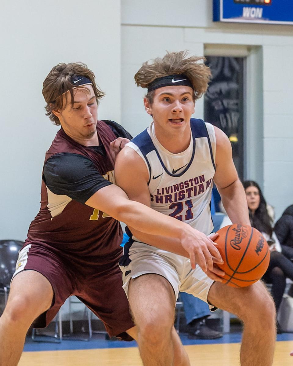 Livingston Christian's Levi Martin (21) handles the basketball while defended by Charyl Stockwell's Henry Munkres on Tuesday, Feb. 1, 2022.