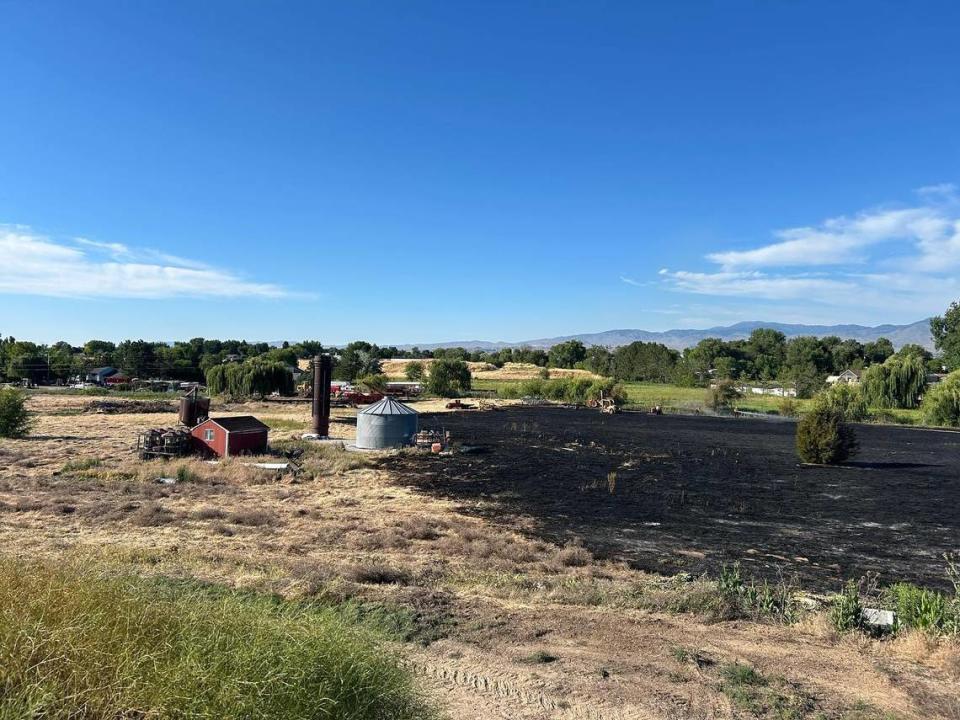 Crews stopped the 2-acre fire before it reached machinery and outbuildings.