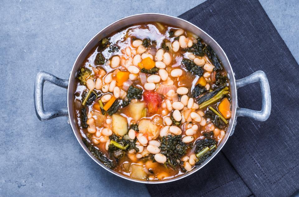 Ribollita, a rich, rustic Tuscan soup of cannellini beans, cavolo nero, carrots, and celery - travelbook - Fotolia