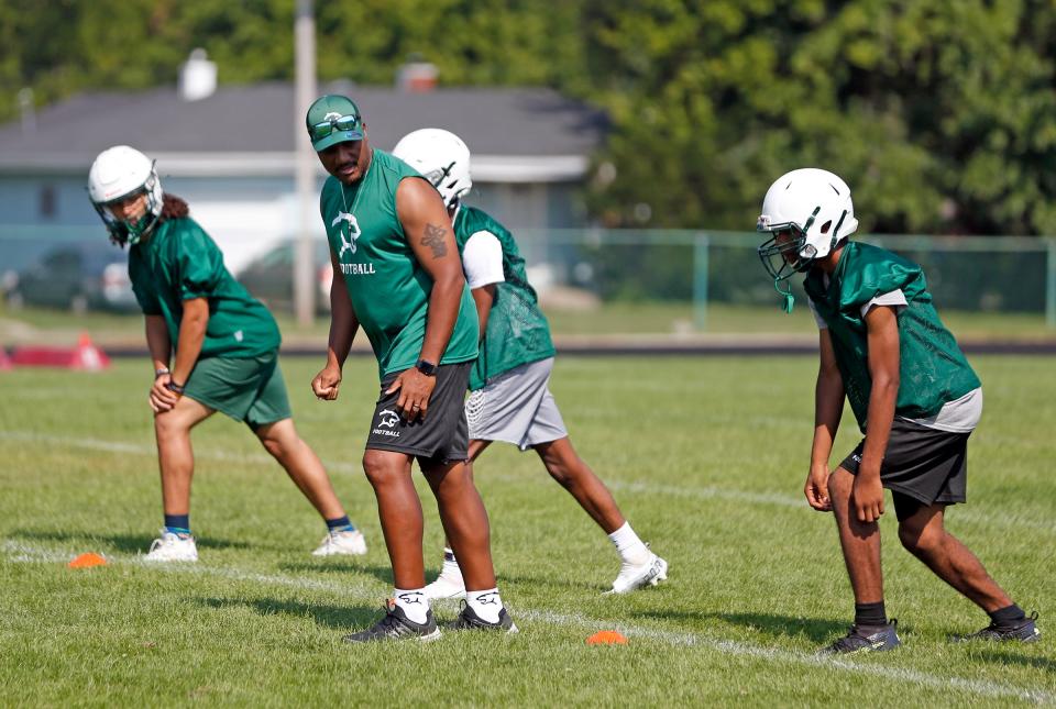 South Bend Washington football head coach Jay Johnson works with the wide receivers during practice Friday, August 4, 2023, at Washington High School in South Bend. It's Johnson's first year back coaching the program after a four-year hiatus.
