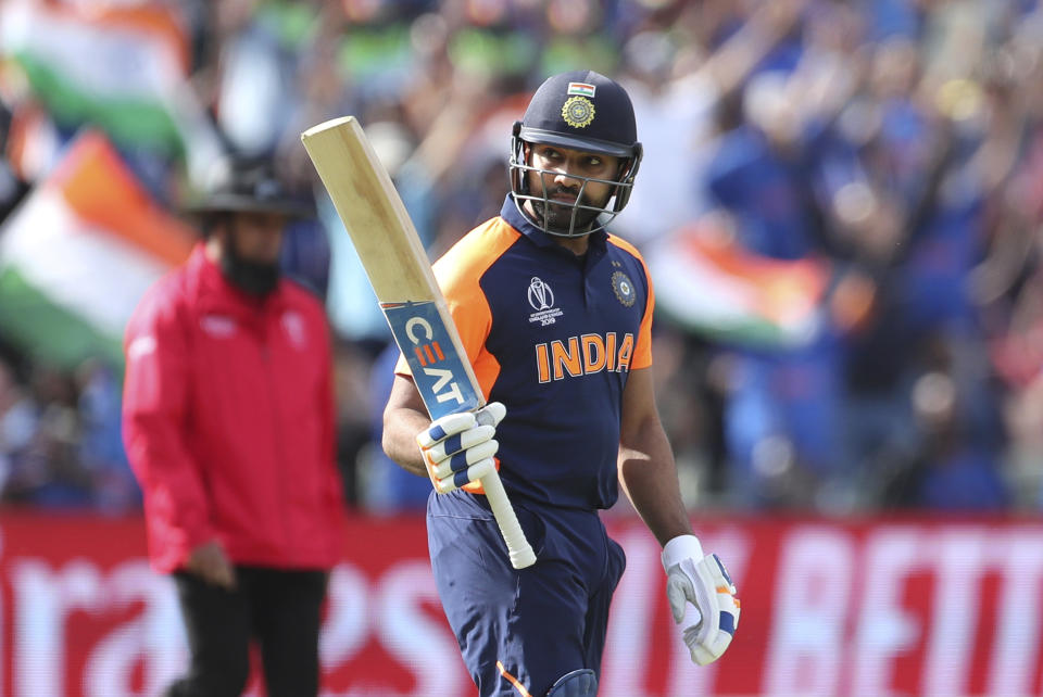 India's Rohit Sharma raises his bat to celebrate scoring a century during the Cricket World Cup match between England and India at Edgbaston in Birmingham, England, Sunday, June 30, 2019. (AP Photo/Aijaz Rahi)