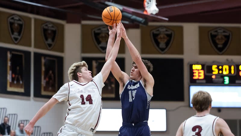 Corner Canyon’s Brody Kozlowski shoots over Lone Peak’s Luke Fotheringham in a high school boys basketball game in Highland on Tuesday, Jan. 24, 2023.