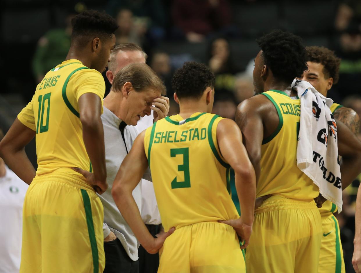 Oregon coach Dana Altman, center left, brings his team together during a timeout against Kent State at Matthew Knight Arena Dec. 21, 2023.