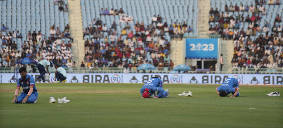 Afghanistan players pray during a drink break at the ICC Men's Cricket World Cup match between Afghanistan and Netherlands in Lucknow, India, Friday, Nov. 3, 2023. (AP Photo/Altaf Qadri)