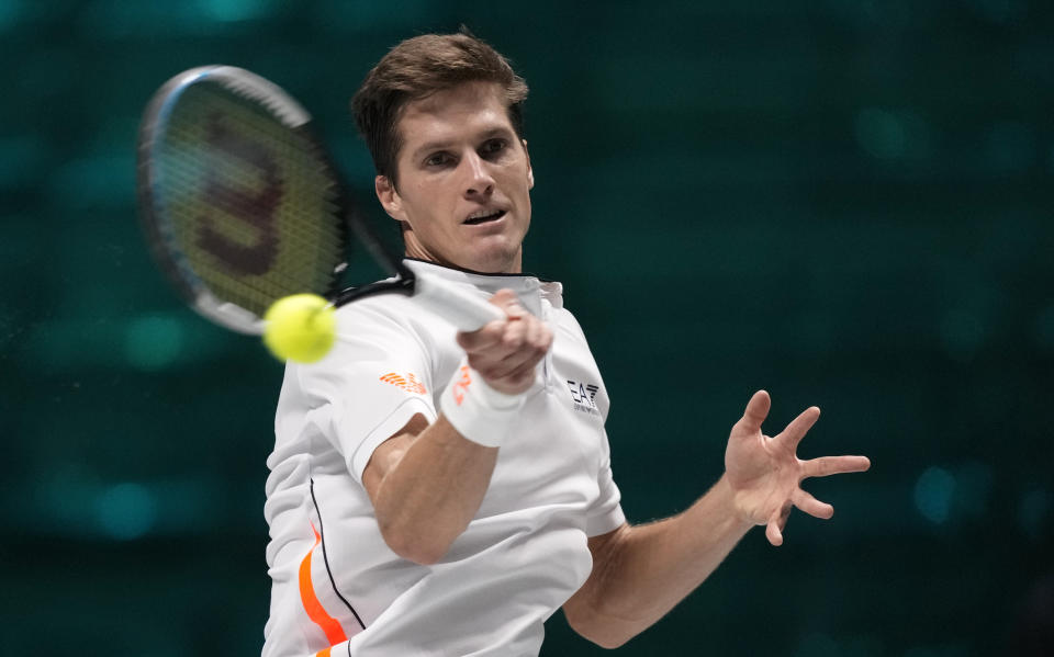 Croatia's Nino Serdarusic returns the ball to Hungary's Fabian Marozsan during their Davis Cup men's single Finals tennis match at the Pala Alpitour in Turin, Italy, Sunday, Nov. 28, 2021. (AP Photo/Antonio Calanni)