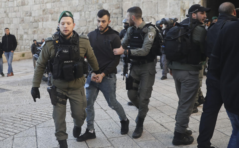 Israeli border police arrests a Palestinian ahead of a protest against Middle East peace plan announced Tuesday by US President Donald Trump, which strongly favors Israel, in Jerusalem, Wednesday, Jan 29, 2020. (AP Photo/Mahmoud Illean)