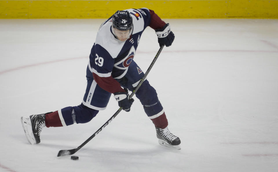 Colorado Avalanche center Nathan MacKinnon shoots during the second period of the team's NHL hockey game against the St. Louis Blues in Denver, Saturday, April 3, 2021. (AP Photo/Joe Mahoney)