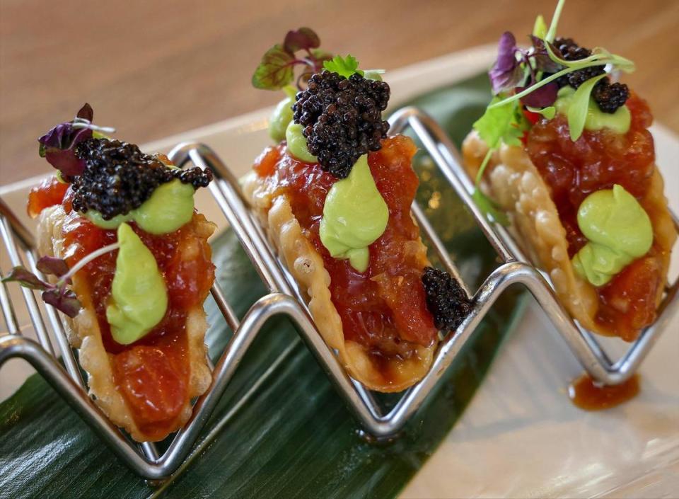 Chef Giovanni Pisfil prepared “Ahi Tuna Tacos” (gyoza crispy shell, ginger sesame, yuzu-avocado mousse, and caviar) is some of delicious offerings at Bayshore Club at the Coconut Grove eatery on Wednesday, March 29, 2023 in Miami, Florida.