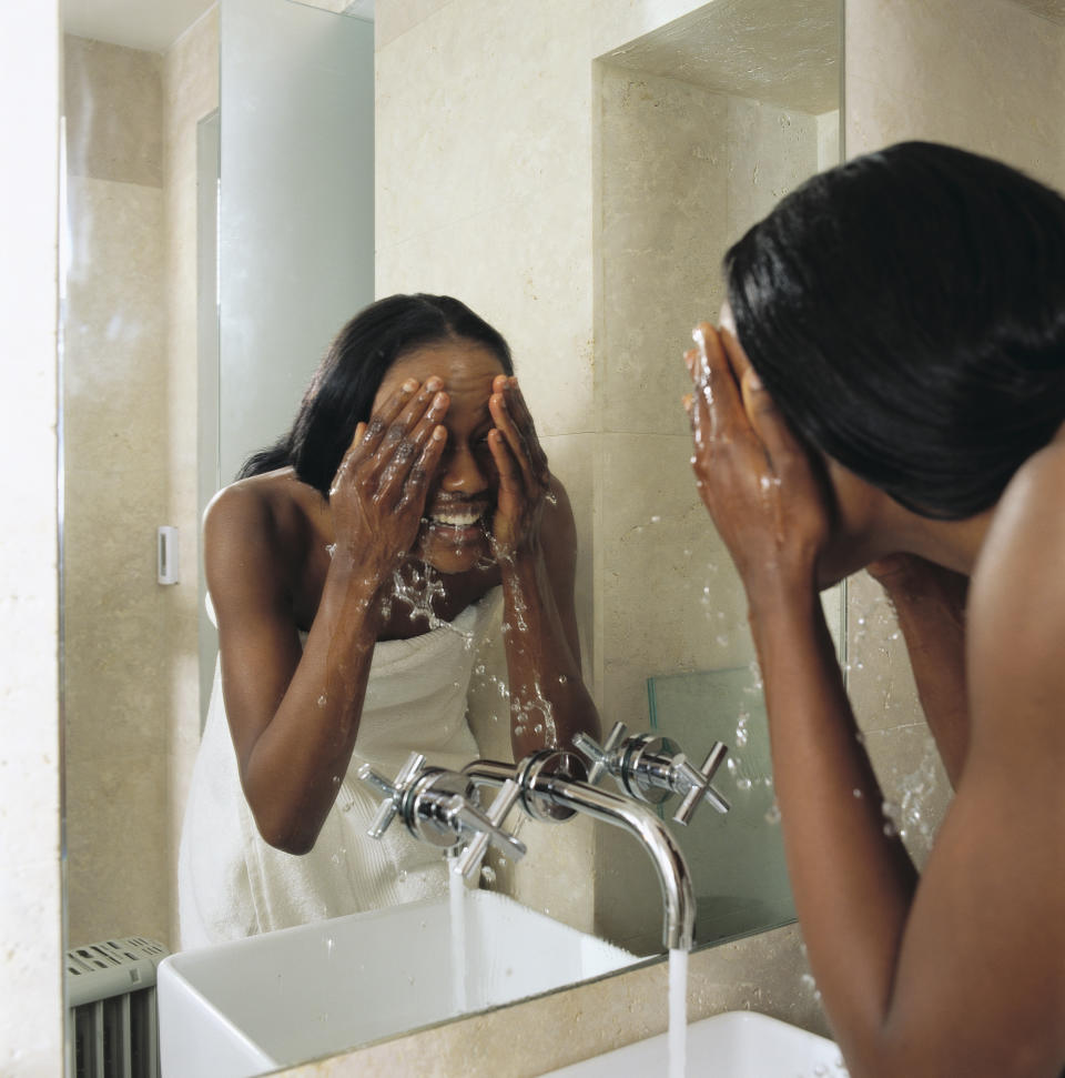 woman washing her face