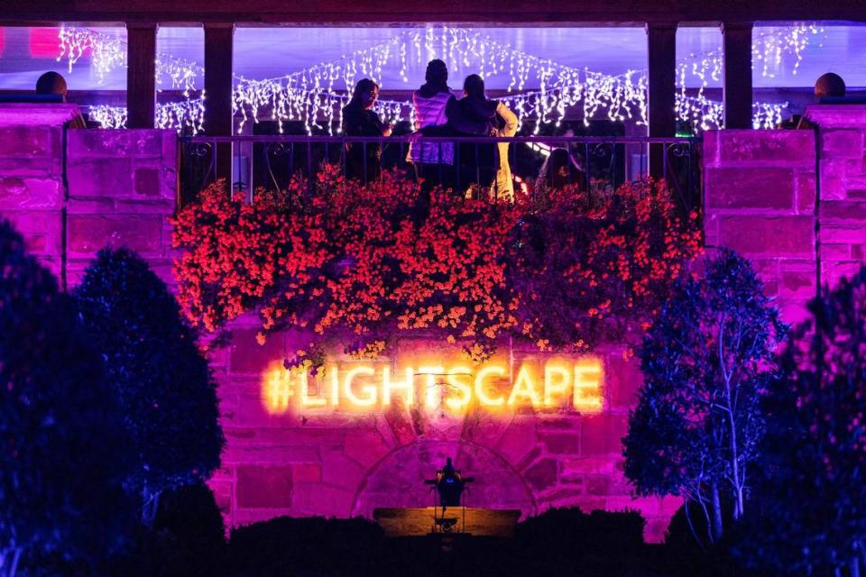 Guests take photos at the top of the ‘Bluebonnet’ display for the Lightscape 2023 event at the Fort Worth Botanic Gardens on Friday, Nov. 24, 2023.