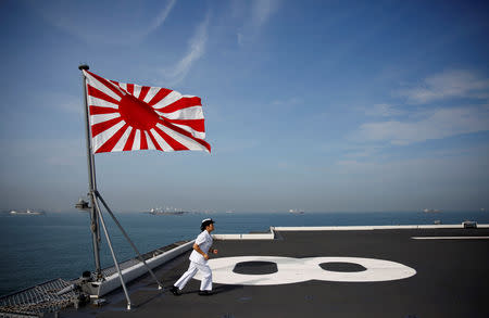 Yuma Osaki, a navigator, runs back to her post after a flag raising ceremony on the flight deck of Japanese helicopter carrier Kaga before its departure for naval drills in the Indian Ocean, Indonesia, September 22, 2018. Women serving on Japan's biggest warship, the Kaga, are a tight-knit group on the frontline of a push to transform the Japanese navy into a mixed-gender fighting force, where men outnumber them more than 10 to one. REUTERS/Kim Kyung-Hoon