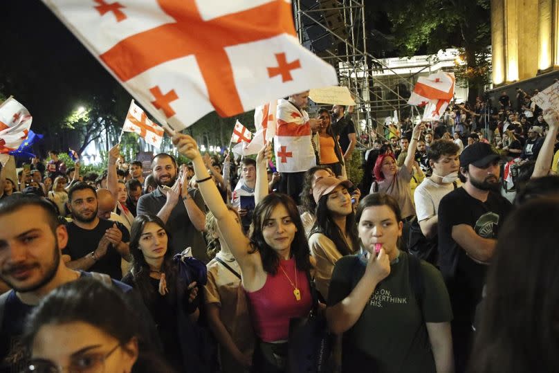 Demonstrators wave Georgian national flag during an opposition protest against "the Russian law" near the Parliament building in Tbilisi, Georgia, on Wednesday, May 1, 2024.