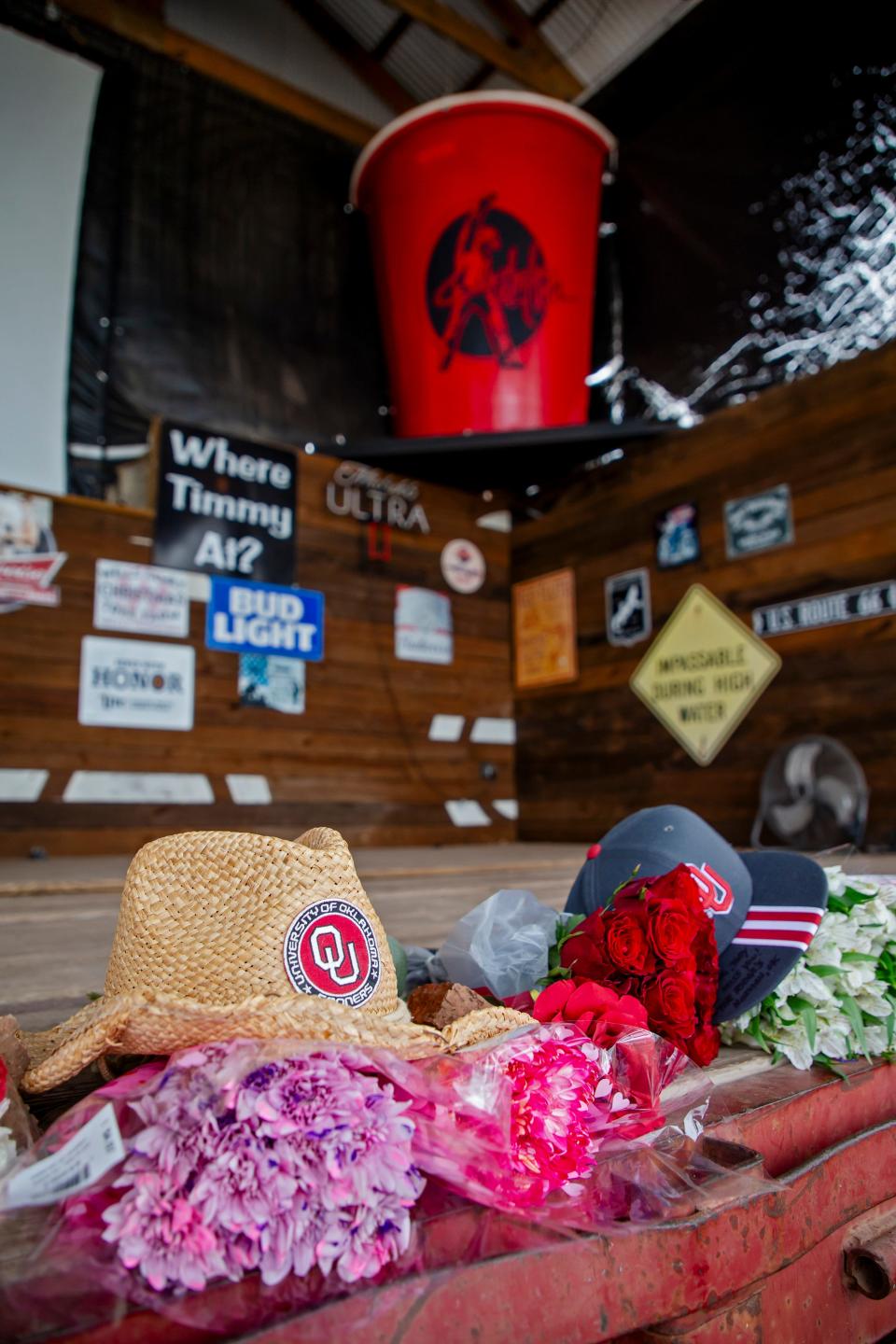 Flowers and other items are placed on the stage at Hollywood Corners on Feb. 7 to pay tribute to Toby Keith in Norman.
