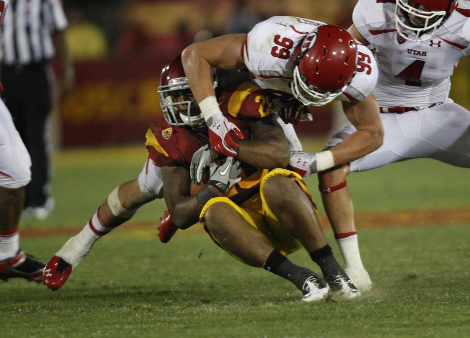 Utah Utes defensive end Joe Kruger stops USC Trojans running back Dillon Baxter as the during game Los Angeles Memorial Coliseum in the first ever Pac-12 game Saturday, Sept. 10, 2011, in Los Angeles, Calif. | Tom Smart, Deseret News