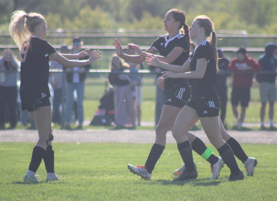 Cheboygan players celebrate a game-tying goal scored by senior Kenzie Burt (3) during the second half of a district clash with TC St. Francis on Thursday.