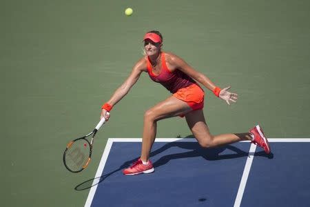 Kristina Mladenovic of France returns a shot to Roberta Vinci of Italy during their quarterfinals match at the U.S. Open Championships tennis tournament in New York, September 8, 2015. REUTERS/Adrees Latif