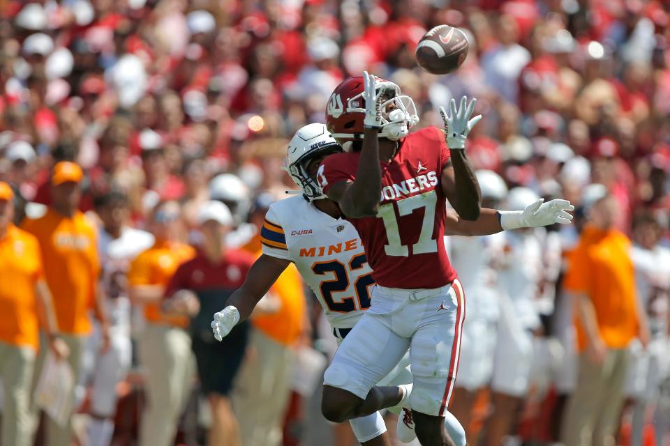 Oklahoma's Marvin Mims (17) catches a pass beside UTEP's Josiah Allen (22) during last Saturday's game in Norman.