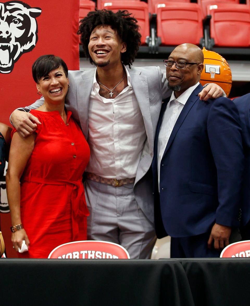 Jaylin Williams is all smiles at the Grizzly Arena in Fort Smith, Arkansas, as he embraces his mom, Linda Williams (left) and his dad, Mike Williams (right), after he was selected 34th overall by the Thunder in the NBA Draft on June 23.