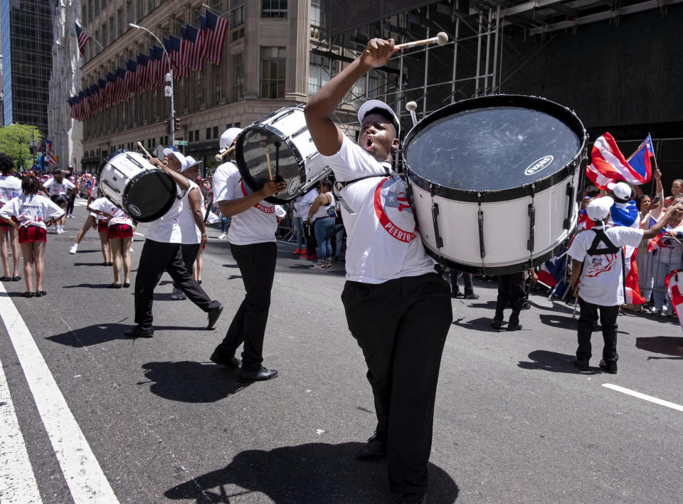 A parade unit entertains spectators during the National Puerto Rican Day Parade Sunday, June 9, 2019, in New York. (AP Photo/Craig Ruttle)
