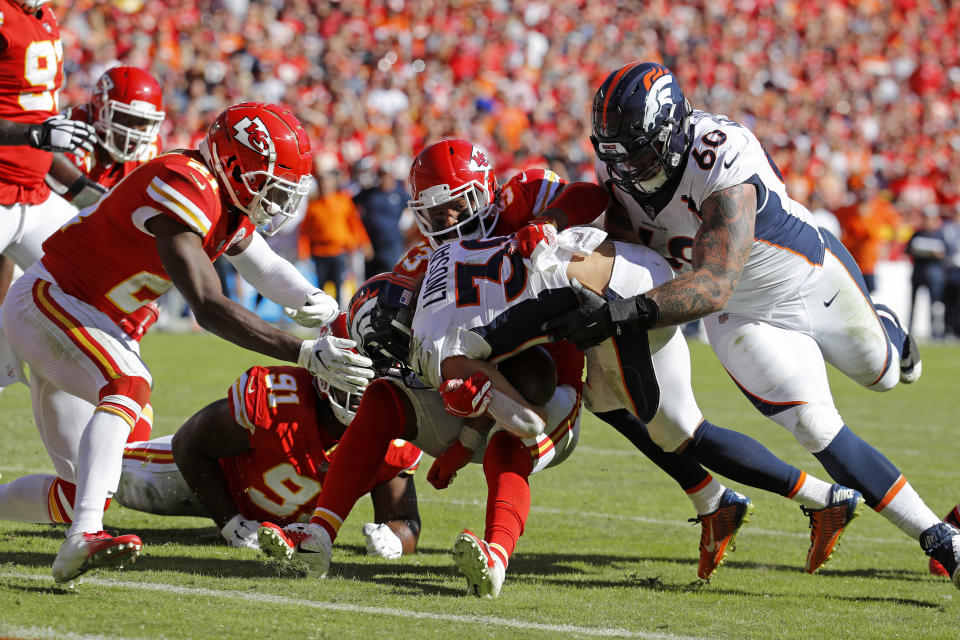 Kansas City Chiefs defensive back Eric Murray (21), linebacker Anthony Hitchens (53) and defensive lineman Derrick Nnadi (91) stop Denver Broncos running back Phillip Lindsay (30) from scoring a two-point conversion with offensive guard Connor McGovern (60) during the second half of an NFL football game in Kansas City, Mo., Sunday, Oct. 28, 2018. (AP Photo/Charlie Riedel)