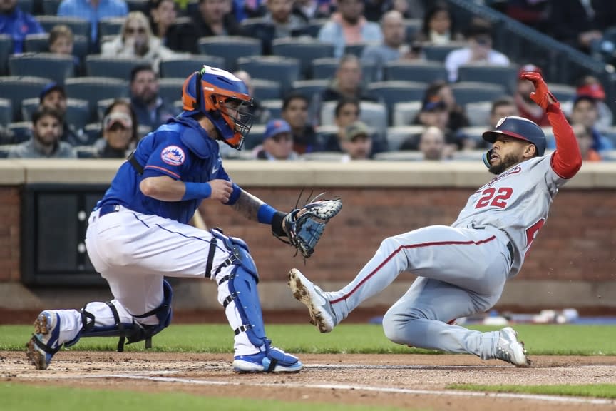 Washington Nationals first baseman Dominic Smith (22) scores ahead of the tag of New York Mets catcher Tomas Nido (3) in the second inning at Citi Field.