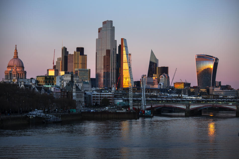 The evening light on the City of London skyline by the river Thames