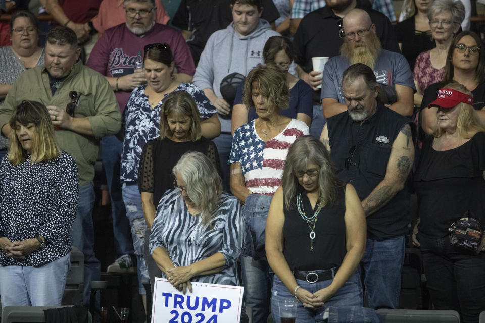 Trump supporters pray together at the South Dakota Republican Party Monumental Leaders rally Friday, Sept. 8, 2023, in Rapid City, S.D. (AP Photo/Toby Brusseau)