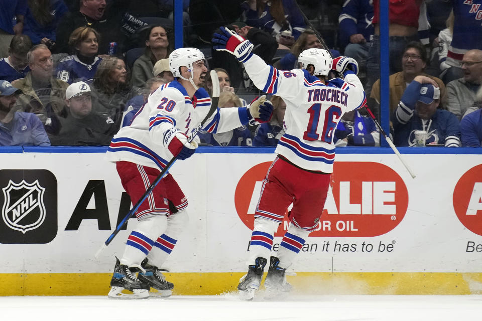 New York Rangers left wing Chris Kreider (20) celebrates his goal against the Tampa Bay Lightning with center Vincent Trocheck (16) during the second period of an NHL hockey game Saturday, Dec. 30, 2023, in Tampa, Fla. (AP Photo/Chris O'Meara)