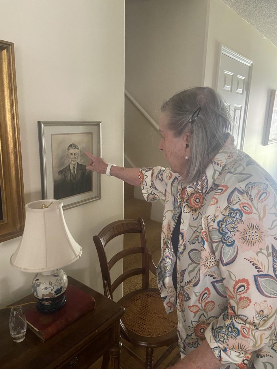 Tillie Stacy points to a framed sketch of her grandfather, who served as harbor master for the Savannah River and kept the harbor safe from the enemy during World War I.