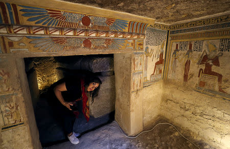 Tourist is being surrounded by paintings inside the newly discovered burial site, Tomb of Tutu, at al-Dayabat, Sohag, Egypt April 5, 2019. REUTERS/Mohamed Abd El Ghany