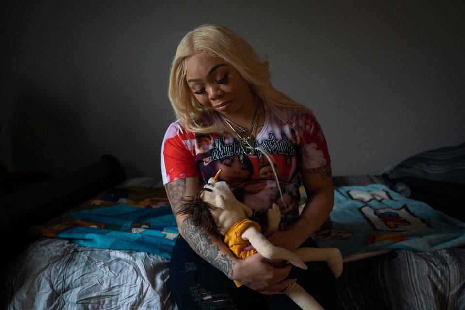 Crystal Cooper holds a stuffed toy doll named Jeffy that belonged to her son LaMar Mitchell, 9, while sitting inside his bedroom at their home in Swartz Creek, Thursday, Jan. 12, 2023. "LaMar loved this thing," said mother Crystal Cooper. "I have a little one I carry with me everyday. When I'm having a bad day it's like my comfort."