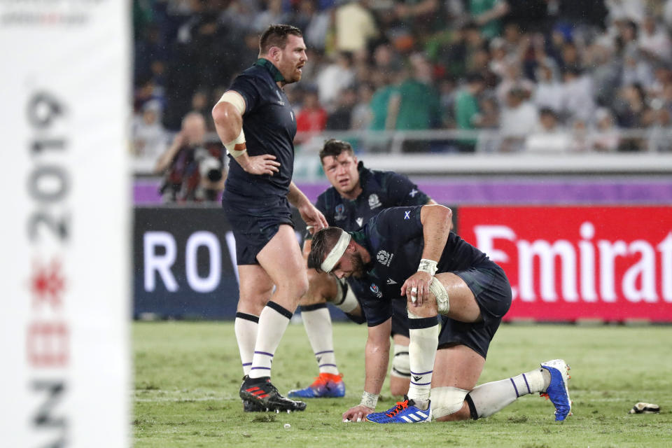 Scotland's players react after their loss in the Rugby World Cup Pool A game at International Stadium between Ireland and Scotland in Yokohama, Japan, Sunday, Sept. 22, 2019. (AP Photo/Eugene Hoshiko)