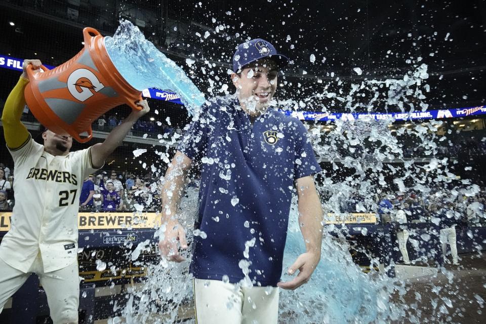 Milwaukee Brewers' Willy Adames douses starter Robert Gasser after a baseball game against the St. Louis Cardinals Friday, May 10, 2024, in Milwaukee. Gasser got a win in his major league debut as the Brewers won 11-2. (AP Photo/Morry Gash)