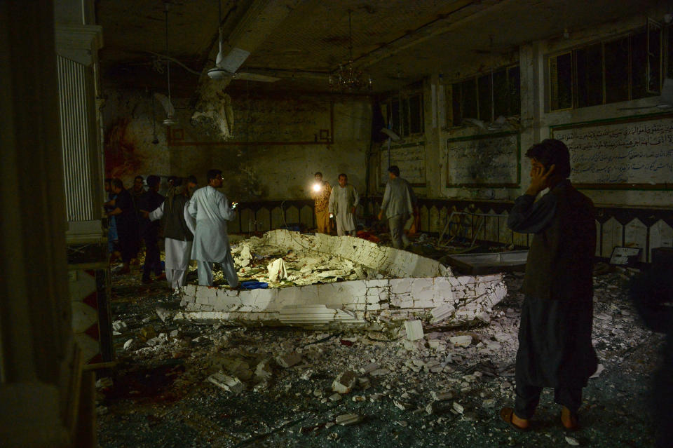 <p>Afghan security personel inspect the site of a suicide bomb attack at a Shiite mosque in Herat on August 1, 2017. (Photo: Hoshang Hashimi/AFP/Getty Images) </p>