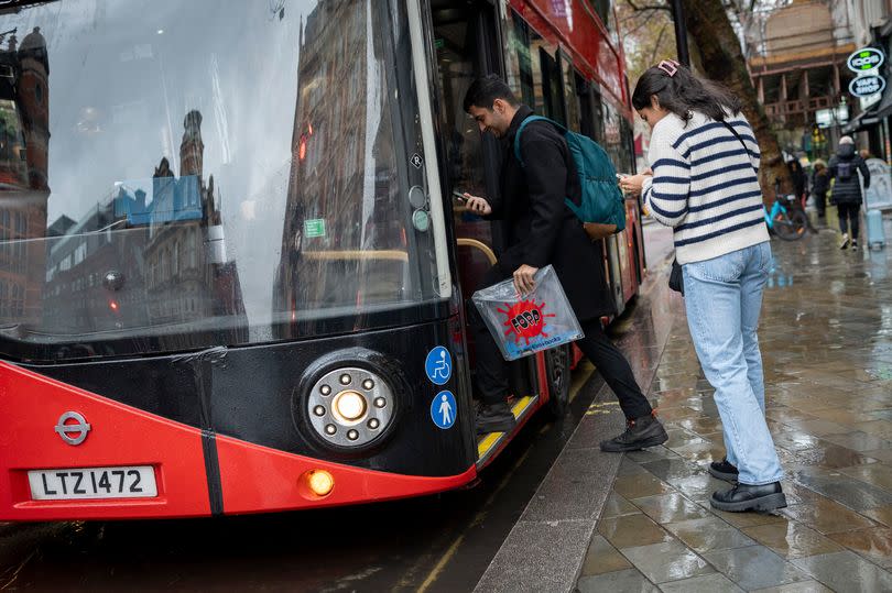 people getting on the bus