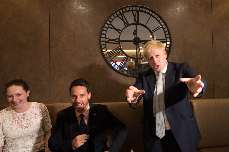 Conservative party leadership candidate Boris Johnson (right) interacts with local business people in the Munch and Wiggles cafe in Oxshott, Surrey.