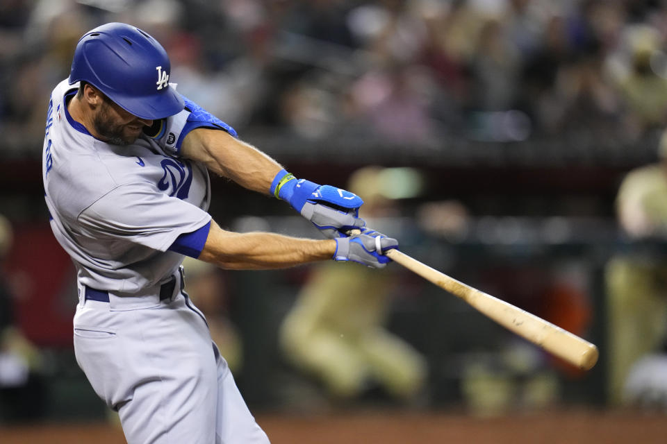 Los Angeles Dodgers' Chris Taylor swings for a home run against the Arizona Diamondbacks during the fourth inning of a baseball game Friday, April 7, 2023, in Phoenix. (AP Photo/Ross D. Franklin)