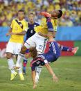 Japan's Yoshito Okubo tries to score past Colombia's Carlos Valdes during their 2014 World Cup Group C soccer match at the Pantanal arena in Cuiaba June 24, 2014. REUTERS/Eric Gaillard (BRAZIL - Tags: TPX IMAGES OF THE DAY SOCCER SPORT WORLD CUP)