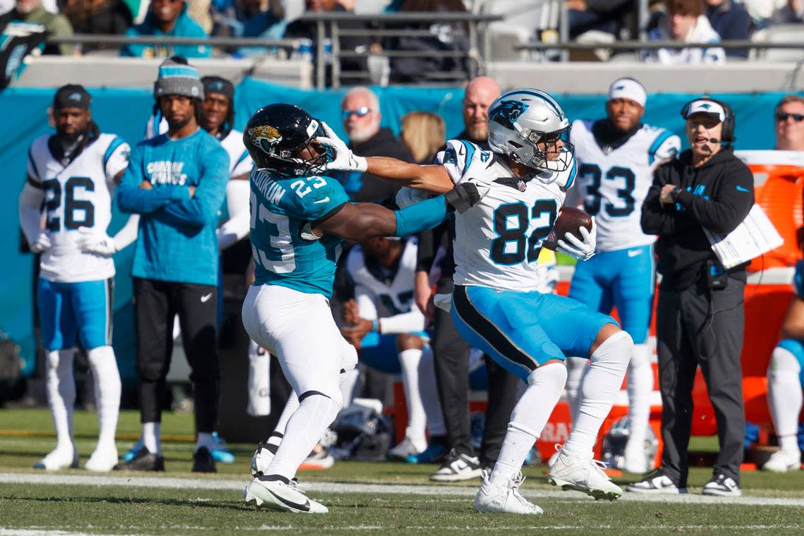 Carolina Panthers tight end Tommy Tremble (82) pushes Jacksonville Jaguars linebacker Foyesade Oluokun (23) away during the second quarter at EverBank Stadium.