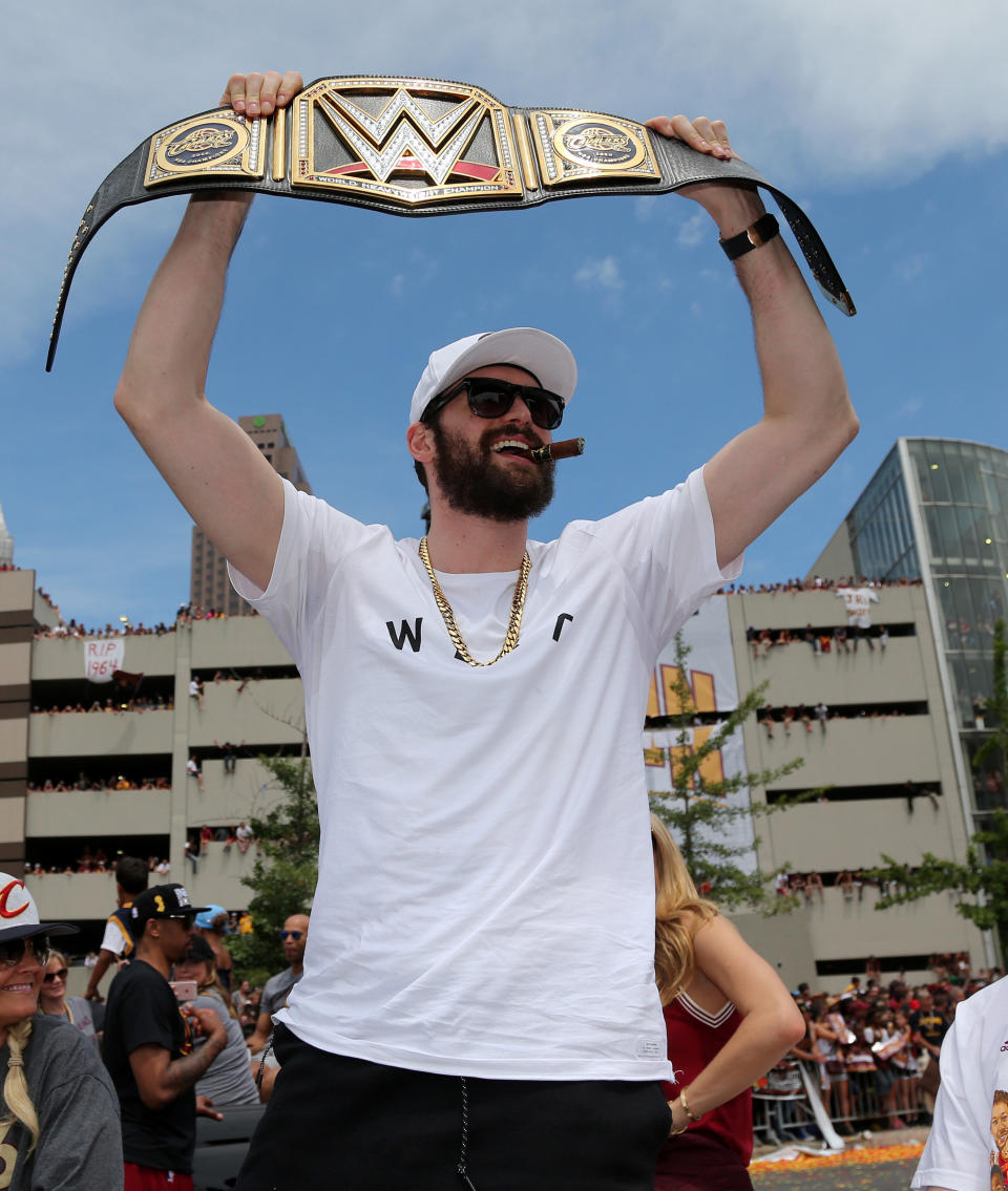 Cleveland Cavaliers Kevin Love holds up a WWE Championship belt during a parade to celebrate winning the 2016 NBA Championship in downtown Cleveland, Ohio, U.S. June 22, 2016. REUTERS/Aaron Josefczyk