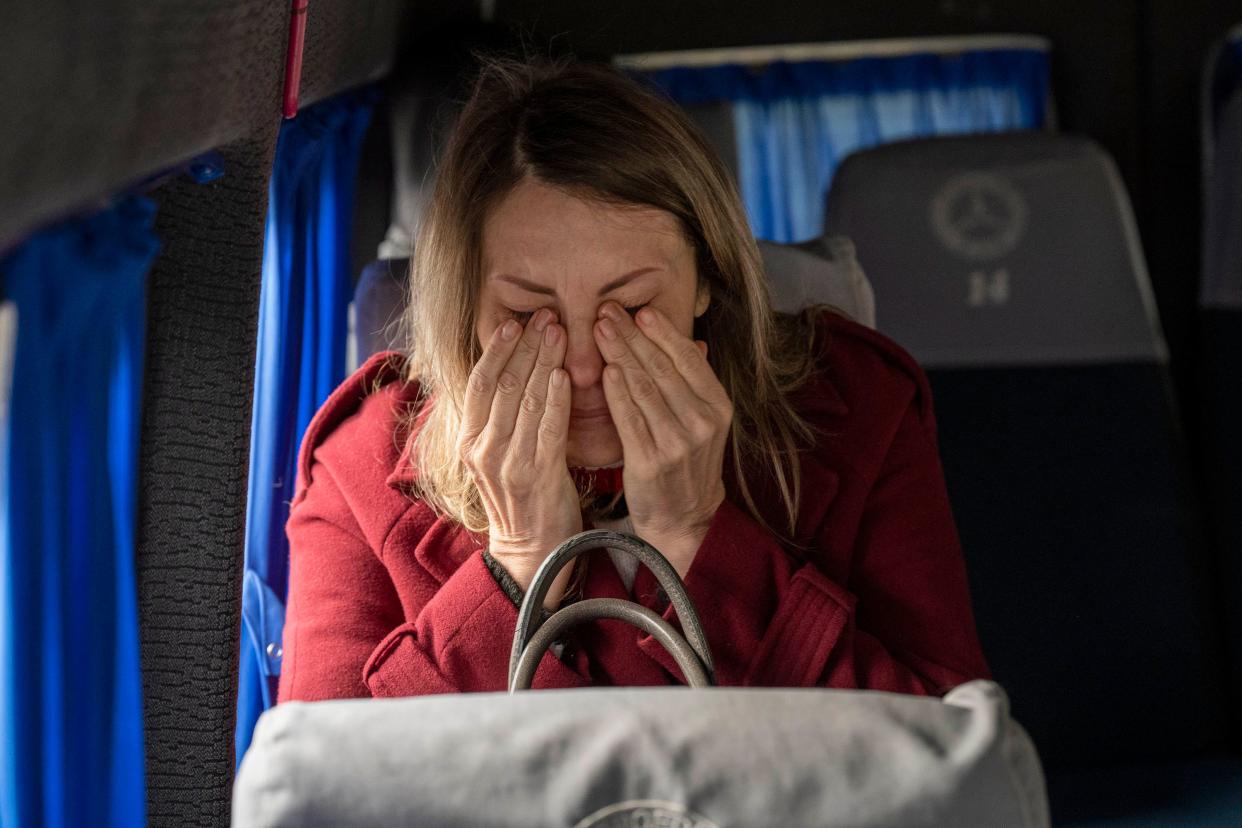 A woman becomes emotional as she boards a Team Humanity Sprinter van to evacuate the besieged city of Chernihiv, Ukraine, after Russian forces retreated on April 7, 2022. This story was produced in partnership with the Pulitzer Center.