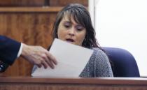 Kelly Rose Belanger, the former bar manager at South Street Cafe in Providence, examines a copy of a receipt while testifying at the murder trial of former New England Patriots NFL football player Aaron Hernandez at Bristol County Superior Court in Fall River, Massachusetts February 26, 2015. Hernandez smoked marijuana and bought food and drinks for friends at a Rhode Island restaurant hours before prosecutors say he fatally shot an acquaintance, Belanger testified on Thursday. REUTERS/Charles Krupa/Pool (UNITED STATES - Tags: SPORT FOOTBALL CRIME LAW)