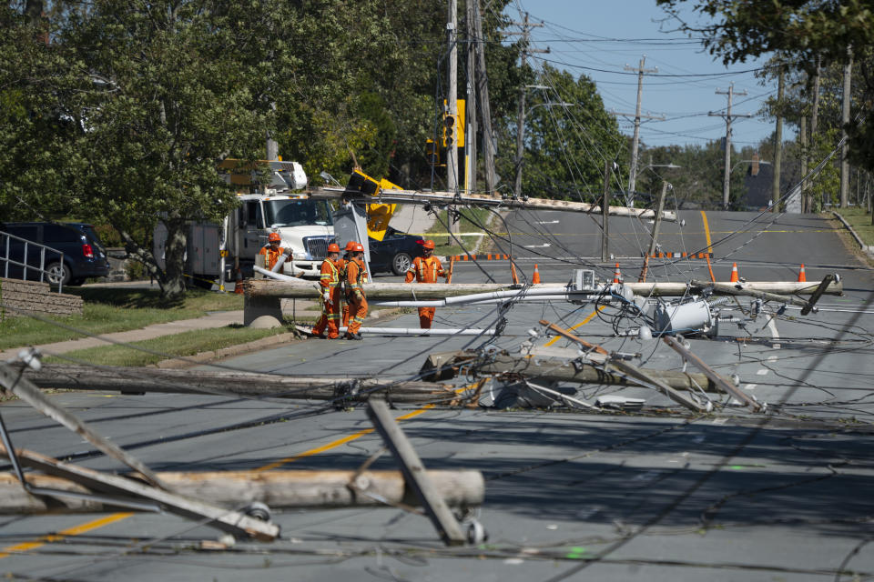 Workers assess downed power poles caused by post-tropical storm Fiona in Dartmouth, Nova Scotia, Sunday, Sept. 25, 2022. Hundreds of thousands of people in Atlantic Canada remain without power and officials are trying to assess the scope of devastation from former Hurricane Fiona. It swept away houses, stripped off roofs and blocked roads across the country’s Atlantic provinces. (Darren Calabrese/The Canadian Press via AP)